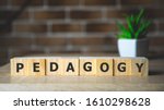 Small photo of Pedagogy word written on wood block. Pedagogy text on wooden table for your desing, concept.