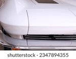 1963 Chevrolet Corvette.  Ermine white with red interior.  Key shots and close up shots of interior and exterior of car to include seats, steering wheel, instruments, hood, tire, headlight, tail light