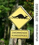 Small photo of Yellow kangaroo warning sign that says attention for swimming kangaroos in dutch language. Zoo Leeuwarden, Friesland, Netherlands