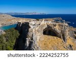 Small photo of Aerial view of the famouse tourist destination in rhodes island. Village Lindos, with the acropolis and the aegan sea. Dodecanese, Greece.