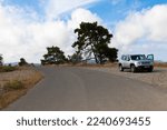Small photo of A white Jeep Renegade is parked on a roadsidein typical creek landscape. Rhodes Island, Greece. October 09,2022