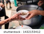 Small photo of The Hand of the Beggars receives charity food from fellow human beings : The concept of humanitarianism : The hands of refugees have been aided by charity food to alleviate hunger : Feeding Concepts