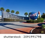 Small photo of Kennedy Space Center, Florida, USA -2021: Entry Plaza with John F Kennedy Fountain, Blue NASA Logo Sphere, Space Shuttle Atlantis external tank and solid rocket boosters.