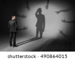 Small photo of Businessman looking at his shadow where many hands reach for him forcing grab his head. Difficulties at work. Problems and issues. Predicament.