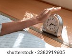 Reach out a hand from futon and turn off the alarm clock