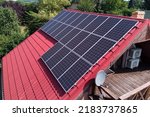 Photovoltaic panels on the roof of a country house from a bird's eye view