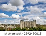 Tall residential buildings construction with nice clouds in blue sky background at Pune, Maharashtra.