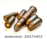 photograph of fired bullets and cartridges, white background