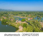 Small photo of Aerial view of Sukhothai Historical Park, buddha pagoda stupa in a temple, Sukhothai, Thailand with green mountain hills and forest trees. Thai buddhist temple architecture. Tourist attraction.