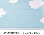 Cute children or baby background, white clouds on the blue wooden background
