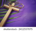 Small photo of Holy Week, Lent, Palm Sunday, Good Friday, Easter Sunday Concept. Crown of thorns, wooden cross and palm leaf with purple background.