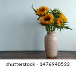 A Pink Vase Of Sun Flowers On A ...