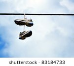 A Pair Of Sneakers Hanging From ...
