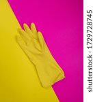 Small photo of color rubber gloves for cleaning on color background, workhouse concept. General or regular cleanup. yellow rubber gloves on background . Cleaning service