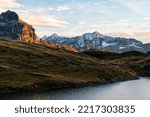 Small photo of sunset at Tannensee lake on a beautiful autum day in the Swiss alps with blue sky and reflection in the water
