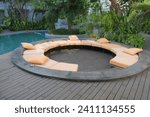 Round seating area with back rest pillows in swimming pool