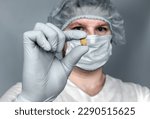 Small photo of Removed Calculus from the kidney, in the doctor's hands. Human urolithiasis. Phosphate or oxalate kidney stone. Urologist surgeon demonstrates a kidney stone. Doctor in medical uniform.