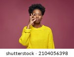 Small photo of Stylish african american young girl showing be quiet gesture, promise to keep secret private information, ask silence