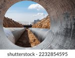 Modern water supply and sewerage system. Underground pipeline works. Water supply and wastewater disposal of a residential city. Close-up of underground utilities. View from the big pipe