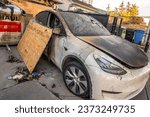 Small photo of Calgary, Alberta, Canada. Oct 10, 2023. An electric Tesla car with fire damage in from a front house garage.