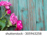 Four Pink Roses On A Wooden...
