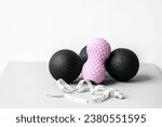 Rubber foam pink peanut roller, black massage ball. Yoga, fitness equipment. Centimeter tape for measuring waist volume. Stretching, pilates accessories. Home workout sport exercises for weight loss.