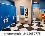 Shared family bright restroom in airport, mall. Unisex WC for mom, dad,little girl boy,child kid. Use together. Recreation room, toilet for adults, daughter,son. Separate cabins for parents,children.