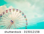 Ferris Wheel On Cloudy Sky...