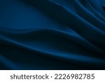 Small photo of Black dark navy blue silk satin fabric cloth. Soft folds. Luxury elegant background for design. Wavy lines. Beautiful. Birthday, Christmas, New Year.