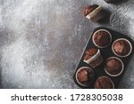 Chocolate brownies cacao muffins flat lay, baking concept, top view, copy space on dark background
