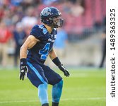 Small photo of Toronto, Canada - July 6, 2019: Toronto Argonauts Linebacker Ian Wild (44) adjusting his position during the BC Lions at Toronto Argonauts game at BMO Field in Toronto, ON