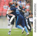 Small photo of Toronto, Canada - July 6, 2019: Toronto Argonauts Defensive end Linden Gaydosh (93) Hitting BC Lions Quarterback Mike Reilly (13) during BC Lions at Toronto Argonauts game at BMO Field in Toronto, ON