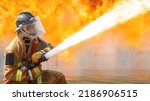 Small photo of Fireman,Firefighter training Firefighters using water and fire extinguishers to fight the flames in emergency situations. in a dangerous situation All firefighters wear firefighter uniforms for safety
