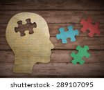 Puzzle head brain concept. Human head profile made from brown paper with a jigsaw piece cut out. Choose your personality that suit you
