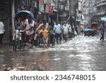 Small photo of Dhaka, Bangladesh August13, 2023. Vehicles try to driving through the waterlogged streets after a heavy downpour in old Dhaka, Bangladesh, on August 13, 2023. After monsoon heavy rains caused waterlog