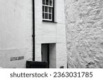 Small photo of Polperro, Cornwall, England UK, July 07 2022: Whitewashed walls and narrow streets with steep inclines typify this ancient smugglers village in Cornwall