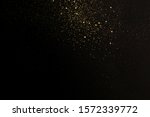 Gold glitter texture on a black background. Holiday background