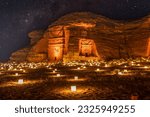 Small photo of Starlight sky over the ancient nabataean tombs of Mada'in Salih Hegra city illuminated, night panorama, Al Ula, Saudi Arabia