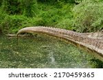 Small photo of Life-threatening crocodile tail. Ruthless and bloodthirsty carnivorous killer. Alarming and scary dinosaur sculpture in dino park. Huge monster figure in the dinosaur park. Dino party. Reptile tail.