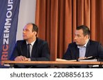 Small photo of Chalons-en-Champagne, France - Sept. 2022 - Town councillors Thomas Adnot, Reconquete's legislative candidate, and Freddy Perin, alternate candidate, sit at a political meeting amid the campaign
