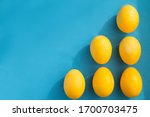 6 yellow easter eggs lie on a...