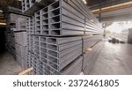 Small photo of Light mouth steel channel or C channel steel for construction materials. C-shaped steel structure. Construction of a factory house building.
