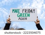 Small photo of Woman holding sign with slogan Make Friday Green Again. Protester with placard at zero waste protest rally. Ecology environmental issues, demonstration against Black Friday Sale, overproduction.