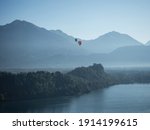 Panoramic view of hot air balloons over Lake Bled castle Blejsko jezero upper carniolan Julian alps mountains in Slovenia Europe