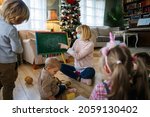 Small photo of Childminder with mask and children playing together. Education, coronavirus concept