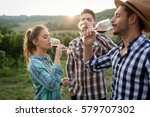 Happy people tasting wine in vineyard