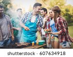 Friends having a barbecue party in nature  while having a blast