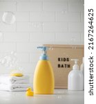 Small photo of Blank bottle of children shampoo accessories and flying soap babbles in bathroom