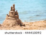 Small photo of Built House sand castle with towers on the south shore of the sandy beach blue sea