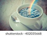 Blue sky cloud with rainbow reflection on Coffee in white cup on wood table , process in vintage style
